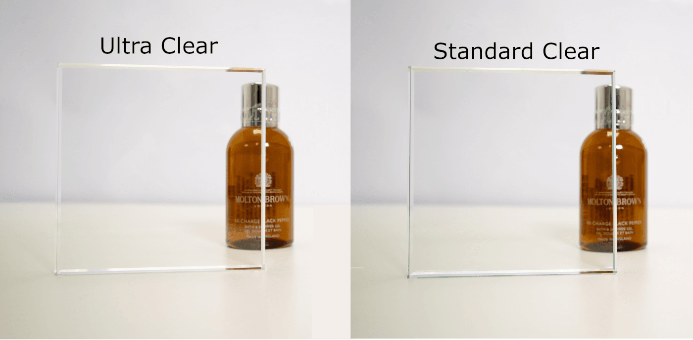 Samples of standard clear and ultra clear shower glass placed in front of a hand soap for reference